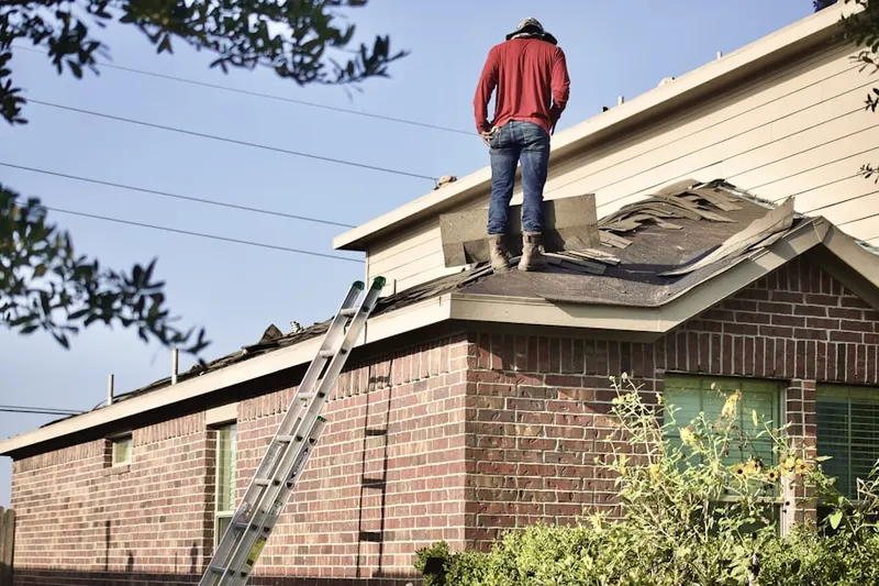 Professional roofer working on a residential roof in Hidden Pond